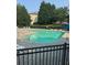 Community pool with seating, complemented by the surrounding lush greenery at 1684 Tailmore Ln, Lawrenceville, GA 30043
