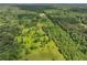 Beautiful aerial view of a vast property with lush green landscape, mature trees, and a private residence at 1971 Centennial Rd, Rutledge, GA 30663