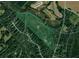 Aerial view of the expansive property with a marker, surrounded by trees and roads at 1971 Centennial Rd, Rutledge, GA 30663