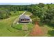 A unique aerial perspective reveals a home nestled within a verdant forest, complete with an inviting outdoor area at 1971 Centennial Rd, Rutledge, GA 30663