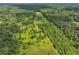 Sweeping aerial view showcases the property's wooded acreage and a long driveway leading to a modern home at 1971 Centennial Rd, Rutledge, GA 30663