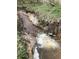 A small creek runs through the property, featuring a charming waterfall among natural surroundings at 1971 Centennial Rd, Rutledge, GA 30663