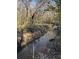 Serene creek winding through a lush forest, reflecting the scenic landscape and surrounding trees at 1971 Centennial Rd, Rutledge, GA 30663