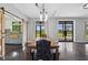 Elegant dining area featuring a wooden table with black accents, barn door and natural light at 1971 Centennial Rd, Rutledge, GA 30663
