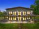 Stunning two-story home at twilight showcasing a spacious deck and modern design elements at 1971 Centennial Rd, Rutledge, GA 30663