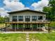 Striking two-story home featuring a spacious deck with modern railings, perfect for outdoor entertaining at 1971 Centennial Rd, Rutledge, GA 30663