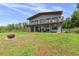 Charming two-story home with a modern metal roof and a spacious yard with a firepit at 1971 Centennial Rd, Rutledge, GA 30663