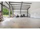 Spacious garage with expansive concrete flooring and open roll-up door at 1971 Centennial Rd, Rutledge, GA 30663