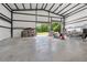 Bright, expansive garage space with an open roll-up door, offering versatility and ample storage at 1971 Centennial Rd, Rutledge, GA 30663