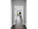 Hallway leading to living space with sleek floors, ample lighting and bright white trim at 1971 Centennial Rd, Rutledge, GA 30663