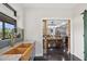 View of the kitchen area with wooden farmhouse sink, modern appliances, and dining room access at 1971 Centennial Rd, Rutledge, GA 30663