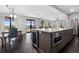 Bright kitchen with stainless appliances, large island, bar seating, and open plan dining area at 1971 Centennial Rd, Rutledge, GA 30663