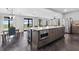 Spacious kitchen island with built-in microwave, wine cooler, and stainless steel refrigerator at 1971 Centennial Rd, Rutledge, GA 30663