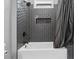 Close-up of shower with dark tile, updated fixtures, recessed shelf and tub at 1971 Centennial Rd, Rutledge, GA 30663