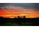 Vibrant orange and yellow sunset over a treeline at 1971 Centennial Rd, Rutledge, GA 30663