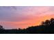 Pastel pink, orange, and yellow sunset over the trees at 1971 Centennial Rd, Rutledge, GA 30663
