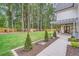 Expansive backyard with lush lawn, wood fence, and patio featuring a pergola with an outdoor kitchen at 2625 Beverly Ln, Snellville, GA 30078