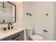 Bright bathroom featuring modern fixtures, gray vanity, tile floors, and a shower with tiled walls at 2625 Beverly Ln, Snellville, GA 30078