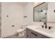 Updated bathroom with gray vanity and tile shower, accented with modern black fixtures and hardware at 2625 Beverly Ln, Snellville, GA 30078