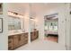 Luxurious bathroom with double vanity, a modern lighting fixture and a view to the connecting bedroom at 2625 Beverly Ln, Snellville, GA 30078