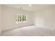 Bright bedroom with decorative walls, neutral carpet, and large windows overlooking a lush landscape at 2625 Beverly Ln, Snellville, GA 30078