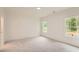 Spacious bedroom with two large windows and decorative wall paneling with neutral carpet at 2625 Beverly Ln, Snellville, GA 30078
