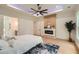 A bright primary bedroom features a modern electric fireplace, accent lighting, and elegant interior design at 2625 Beverly Ln, Snellville, GA 30078