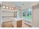 Large walk-in closet with custom shelving, a center island, a chandelier, and natural light from backyard windows at 2625 Beverly Ln, Snellville, GA 30078