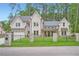 Stunning brick home with black iron fence and manicured lawn, surrounded by mature trees at 2625 Beverly Ln, Snellville, GA 30078