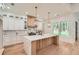 State-of-the-art kitchen featuring a center island, ample counter space, and a stylish backsplash at 2625 Beverly Ln, Snellville, GA 30078