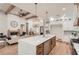 Modern kitchen with a waterfall island, designer lighting, and direct access to living area at 2625 Beverly Ln, Snellville, GA 30078