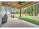 Spacious covered patio with ceiling fan overlooking a manicured backyard with lawn and wooden fence at 2625 Beverly Ln, Snellville, GA 30078