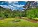 Spacious backyard with a playground set and plenty of green grass and mature trees at 2905 Cammie Wages Rd, Dacula, GA 30019