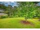 Large backyard with mature trees and plenty of room for outdoor activities at 2905 Cammie Wages Rd, Dacula, GA 30019