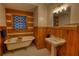 Charming bathroom featuring vintage fixtures, a claw-foot tub, and wood paneled walls at 2905 Cammie Wages Rd, Dacula, GA 30019