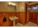 Charming bathroom with wood paneling, pedestal sink, and classic tile flooring at 2905 Cammie Wages Rd, Dacula, GA 30019
