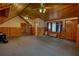 Large bedroom featuring carpeted floors, wood walls, ceiling fan, and entryways at 2905 Cammie Wages Rd, Dacula, GA 30019
