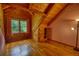 Cozy bedroom featuring wood paneling, hardwood floors, and window with outdoor views at 2905 Cammie Wages Rd, Dacula, GA 30019