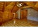 Bedroom featuring hardwood floors, wood walls, ceiling fan, window, and closet at 2905 Cammie Wages Rd, Dacula, GA 30019