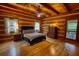 Spacious bedroom with wood-paneled walls, hardwood floors, and a cozy bed and direct access to the balcony at 2905 Cammie Wages Rd, Dacula, GA 30019