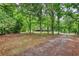 View of the tree-lined front yard and exterior of the home at 2905 Cammie Wages Rd, Dacula, GA 30019
