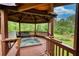 Outdoor hot tub inside a wood-covered gazebo with seating at 2905 Cammie Wages Rd, Dacula, GA 30019