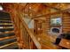 Cozy living room featuring a stone fireplace and wooden staircase at 2905 Cammie Wages Rd, Dacula, GA 30019