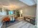 Open dining area featuring modern flooring, glass table, mirrored wall, and ample natural light at 6851 Roswell Rd # D33, Atlanta, GA 30328