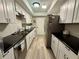 Well-lit kitchen boasts granite counters, stainless steel appliances, and ample cabinet space at 6851 Roswell Rd # D33, Atlanta, GA 30328