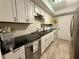 Clean kitchen with granite countertops, white cabinets, and modern stainless steel appliances at 6851 Roswell Rd # D33, Atlanta, GA 30328