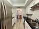 Galley kitchen with stainless steel appliances, black granite countertops, and white cabinets at 6851 Roswell Rd # D33, Atlanta, GA 30328