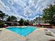 Community pool with plenty of deck chairs, shade, and nice landscaping at 6851 Roswell Rd # D33, Atlanta, GA 30328