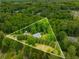Expansive aerial view of a secluded property surrounded by lush greenery at 999 Bailey Rd, Woodstock, GA 30188