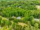 Aerial view of home nestled in a lush wooded area at 999 Bailey Rd, Woodstock, GA 30188